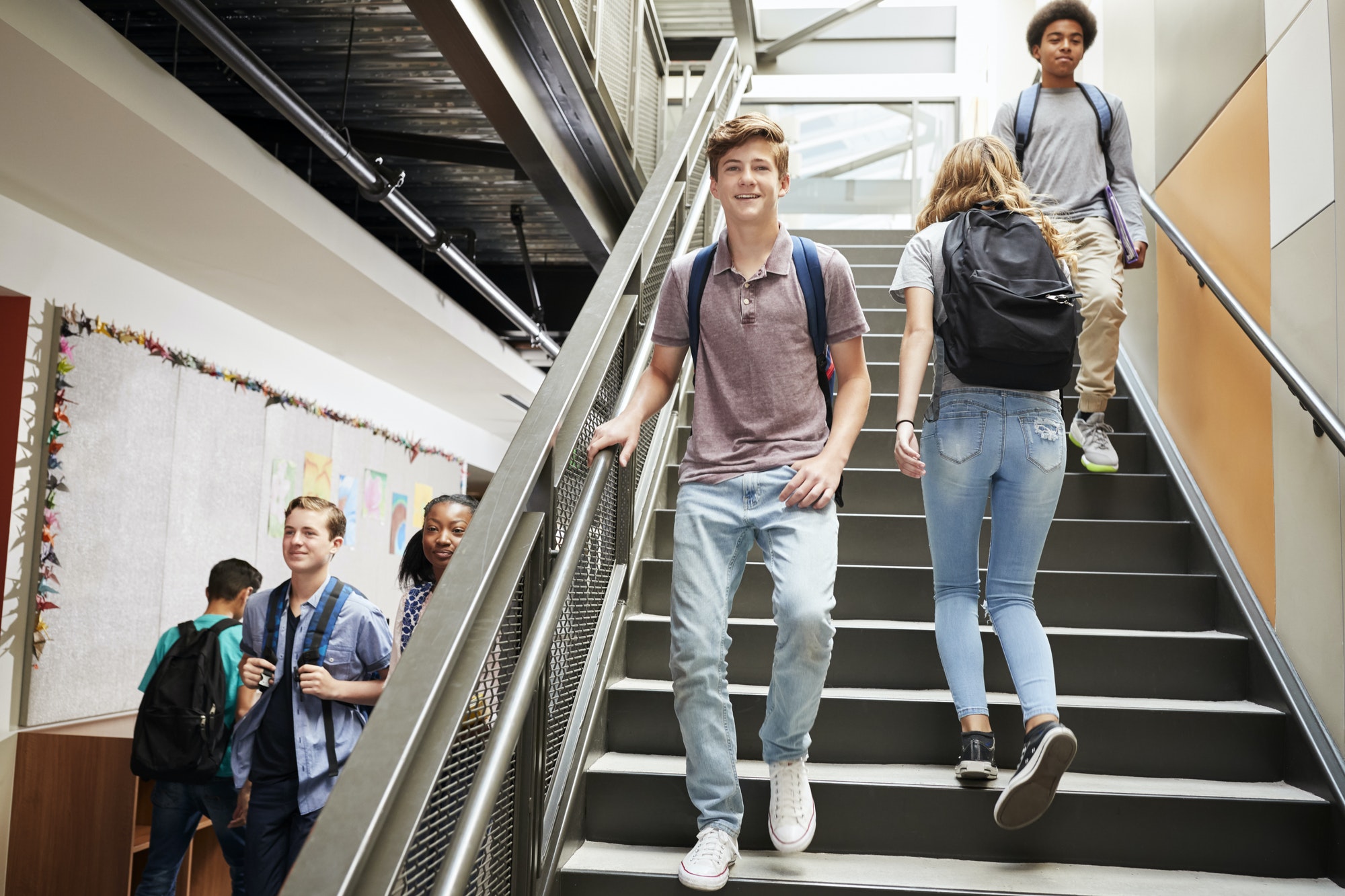 high-school-students-walking-down-stairs-in-busy-college-building.jpg